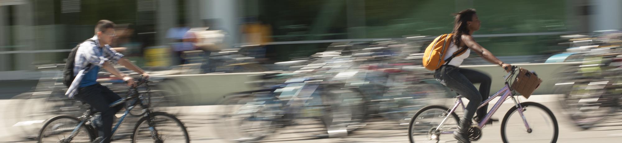 students biking on campus