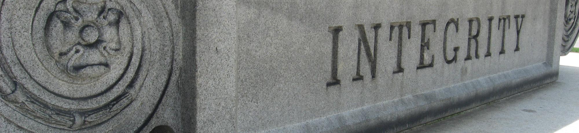 the word 'integrity carved in a stone monument